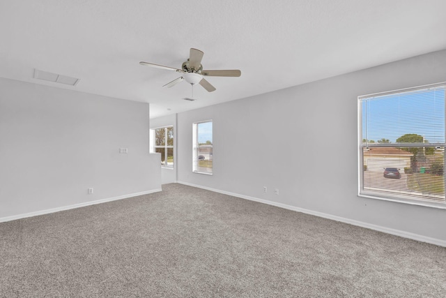 698 SW Mchole Ave, Port Saint Lucie, FL 34953 - carpeted spare room with baseboards, a ceiling fan, and visible vents