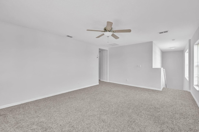698 SW Mchole Ave, Port Saint Lucie, FL 34953 - unfurnished room with carpet, visible vents, baseboards, and ceiling fan