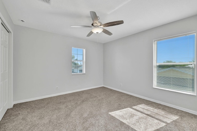 698 SW Mchole Ave, Port Saint Lucie, FL 34953 - unfurnished bedroom featuring a ceiling fan, baseboards, carpet, and a closet