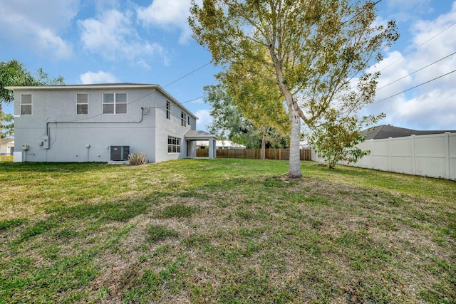 698 SW Mchole Ave, Port Saint Lucie, FL 34953 - view of yard with central air condition unit and a fenced backyard
