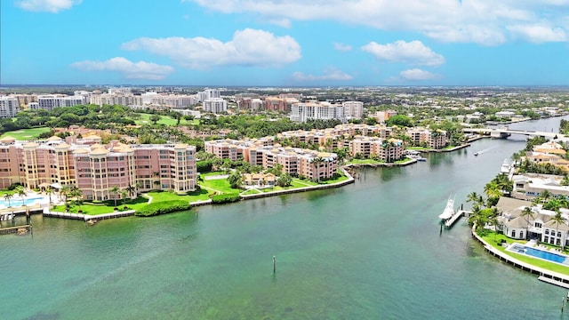 birds eye view of property with a water view and a city view