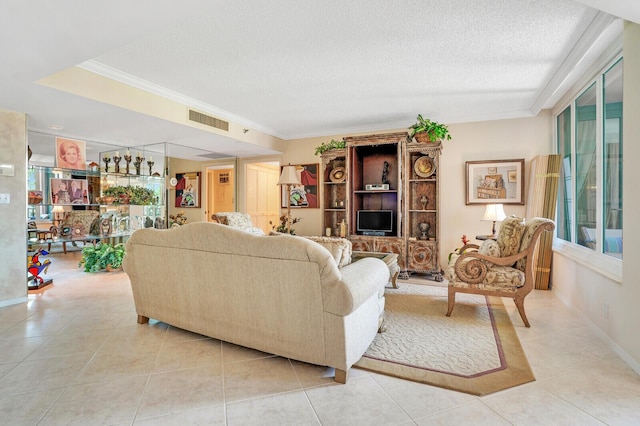 living area with crown molding, visible vents, light tile patterned floors, and a textured ceiling