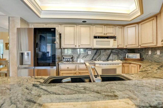kitchen with crown molding, backsplash, white appliances, and light stone counters