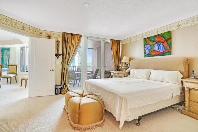 carpeted bedroom featuring access to outside and a textured ceiling