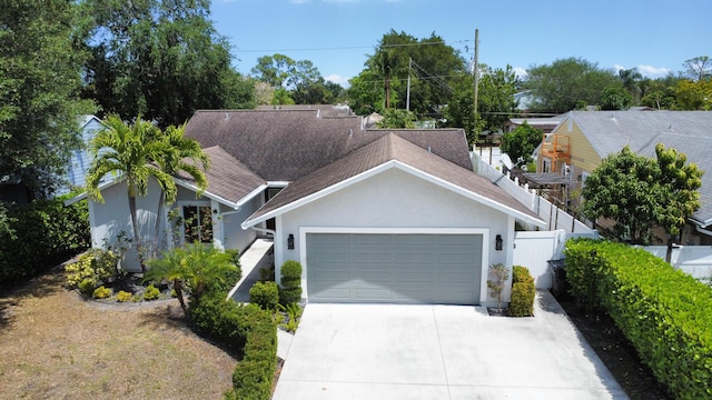 5740 Teakwood Rd, Lake Worth, FL 33467 - single story home with a garage, stucco siding, roof with shingles, fence, and concrete driveway