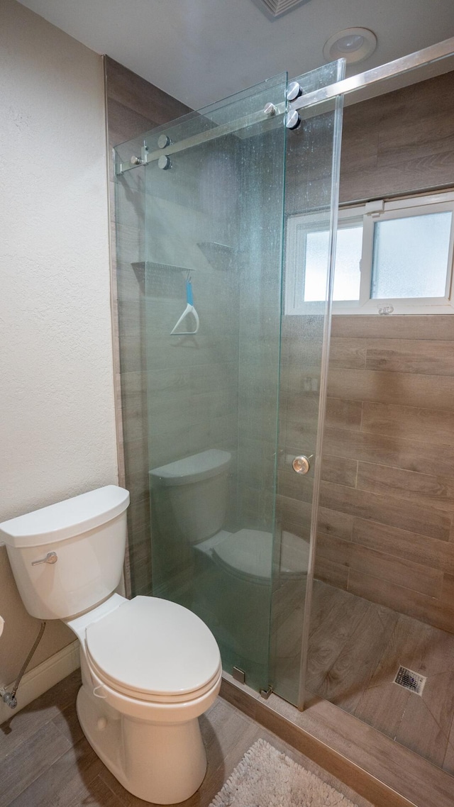 5740 Teakwood Rd, Lake Worth, FL 33467 - bathroom with a stall shower, toilet, and wood finished floors