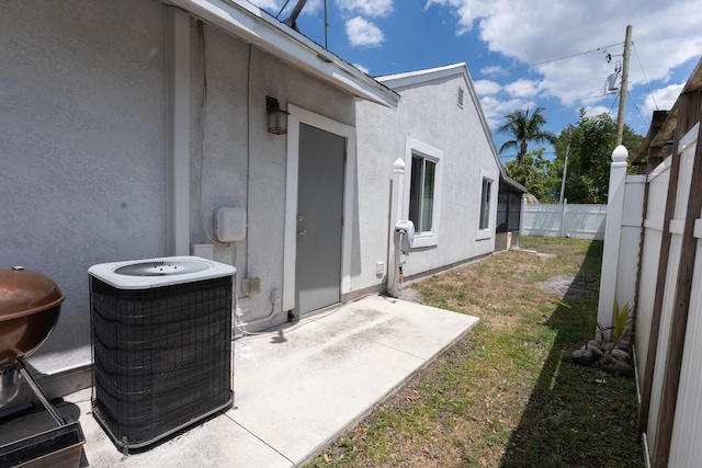5740 Teakwood Rd, Lake Worth, FL 33467 - exterior space featuring a fenced backyard, a patio area, and central AC
