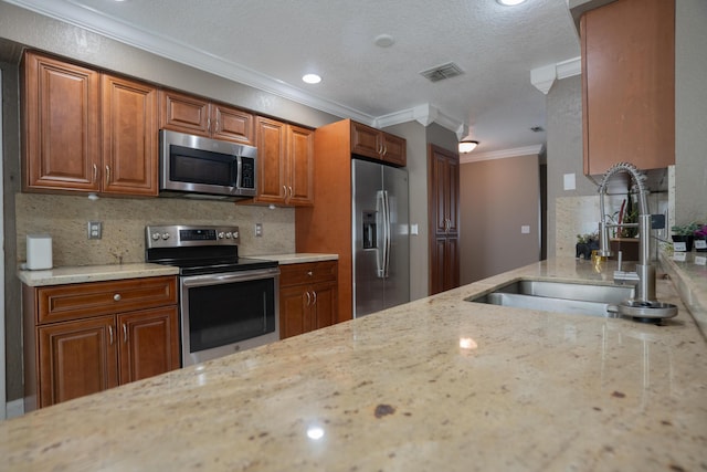 5740 Teakwood Rd, Lake Worth, FL 33467 - kitchen with ornamental molding, visible vents, appliances with stainless steel finishes, light stone counters, and a sink