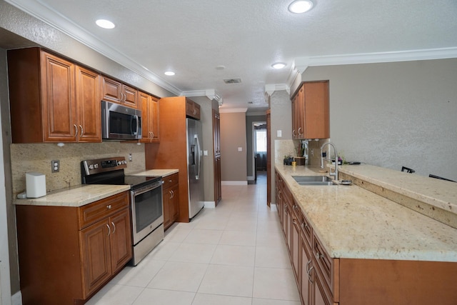 5740 Teakwood Rd, Lake Worth, FL 33467 - kitchen with crown molding, appliances with stainless steel finishes, a sink, brown cabinets, and decorative backsplash