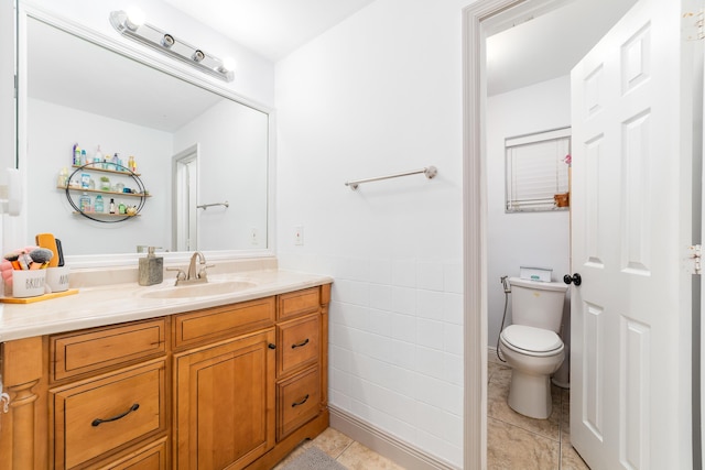 2869 SW 13th Ct, Fort Lauderdale, FL 33312 - bathroom featuring vanity, toilet, tile patterned flooring, tile walls, and wainscoting