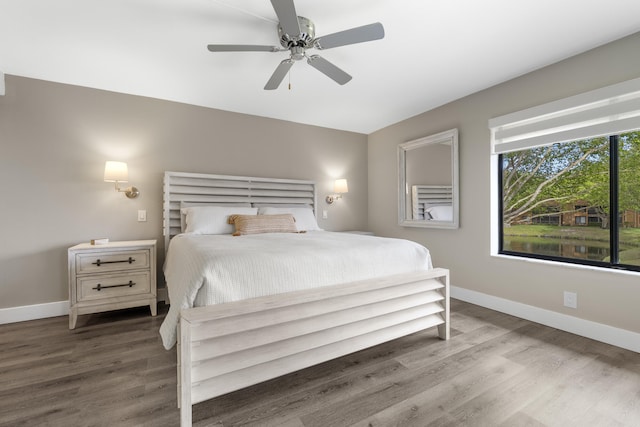 bedroom with baseboards, a ceiling fan, and wood finished floors