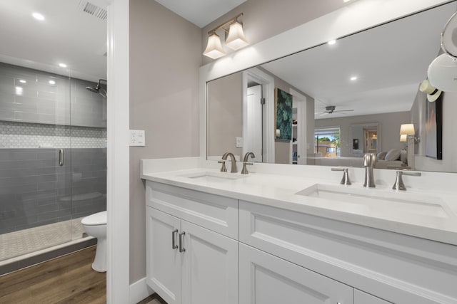 full bath featuring a shower stall, a sink, a ceiling fan, and visible vents