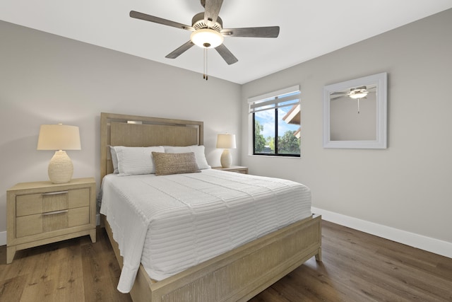 bedroom featuring baseboards, a ceiling fan, and wood finished floors