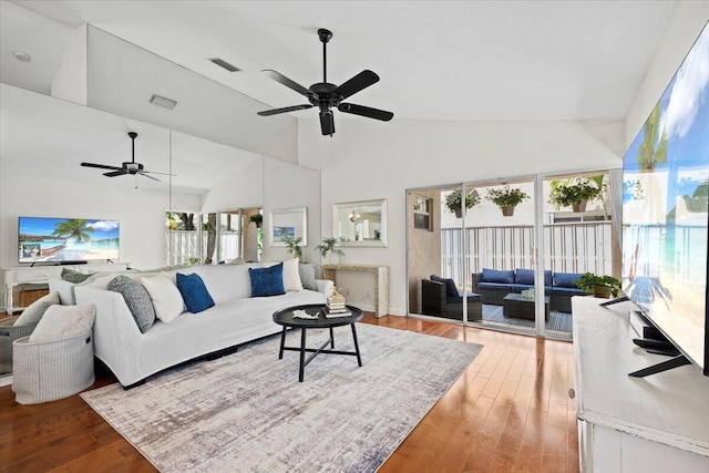 living area featuring a healthy amount of sunlight, visible vents, wood finished floors, and ceiling fan