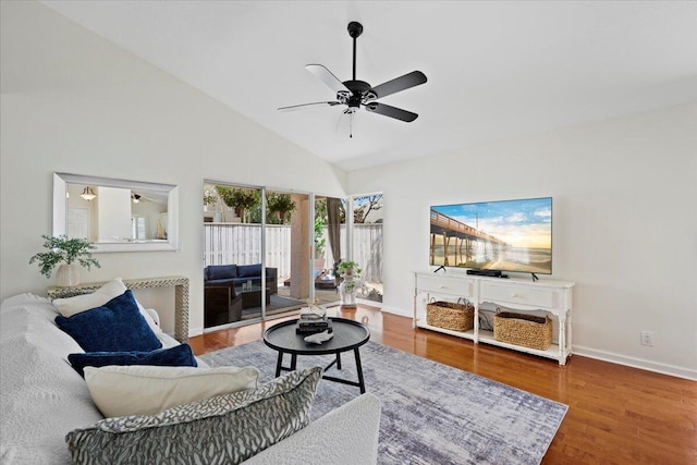 living room featuring baseboards, a ceiling fan, high vaulted ceiling, and wood finished floors