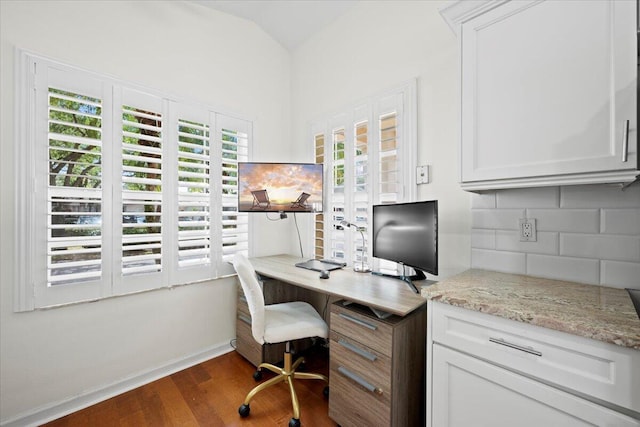 office area with dark wood-style flooring, baseboards, and lofted ceiling
