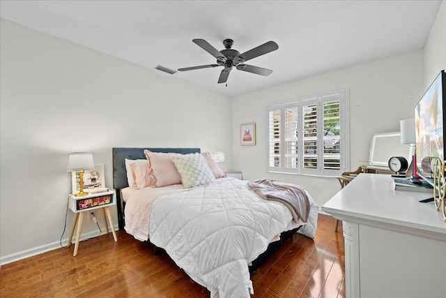 bedroom featuring visible vents, baseboards, a ceiling fan, and wood finished floors