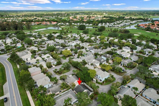 bird's eye view with a residential view, view of golf course, and a water view