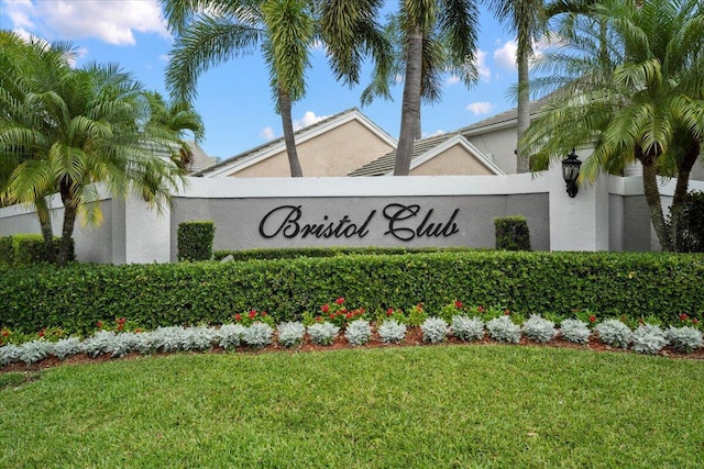 community sign featuring a lawn