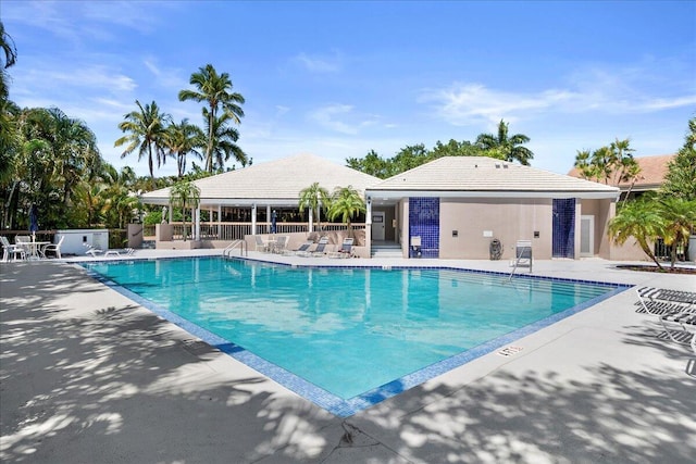 pool featuring a patio and fence