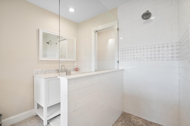 5657 SE Foxcross Pl, Stuart, FL 34997 - bathroom featuring a walk in shower, vanity, and baseboards
