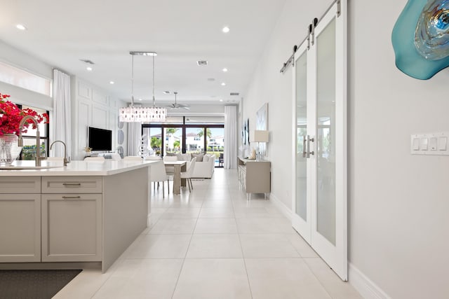 kitchen with open floor plan, light countertops, recessed lighting, gray cabinetry, and light tile patterned flooring