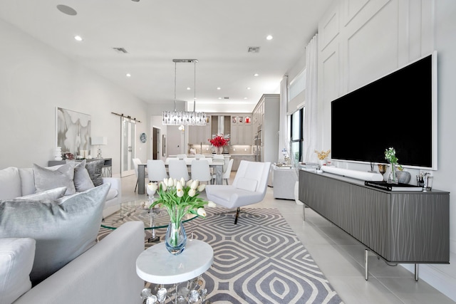 living room featuring a barn door, recessed lighting, light tile patterned floors, and visible vents