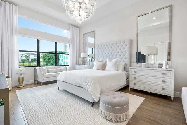 bedroom with recessed lighting, a notable chandelier, baseboards, and wood finished floors