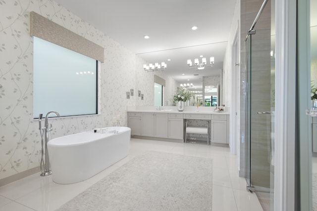 bathroom featuring a stall shower, vanity, a freestanding bath, wallpapered walls, and tile patterned floors