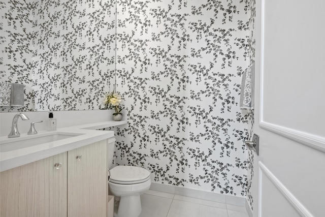 bathroom featuring tile patterned floors, vanity, wallpapered walls, and toilet