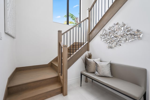 staircase featuring baseboards