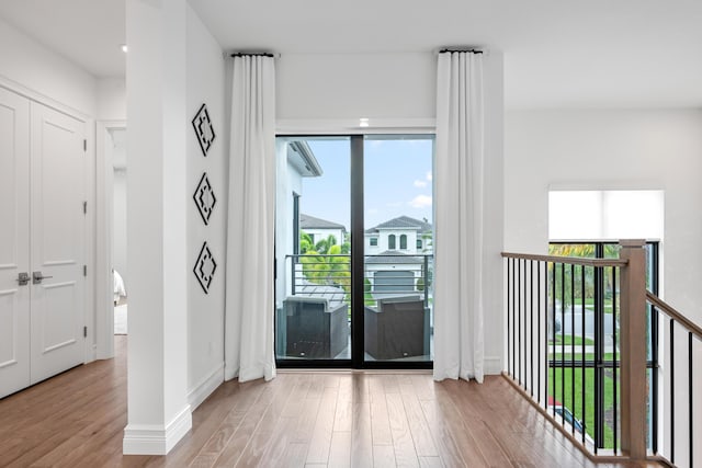 entryway with baseboards and wood finished floors