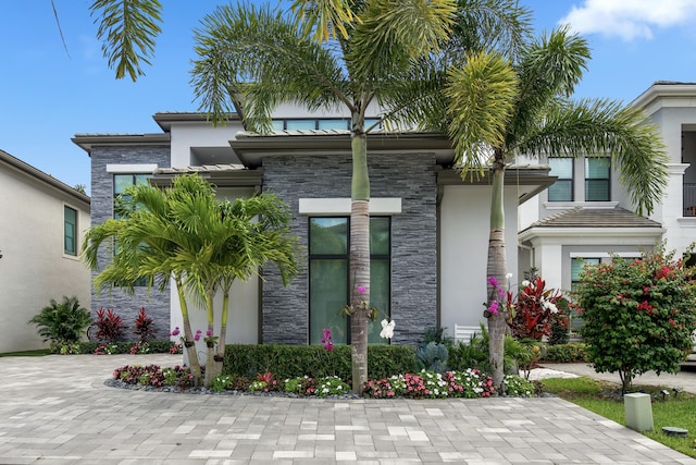 exterior space with stone siding and stucco siding