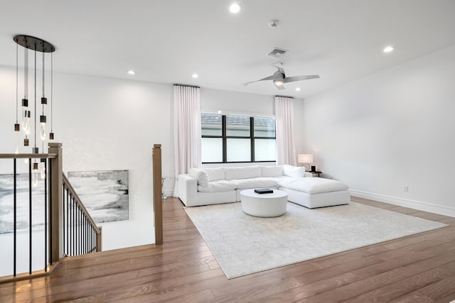 living room featuring hardwood / wood-style floors, ceiling fan, visible vents, and recessed lighting
