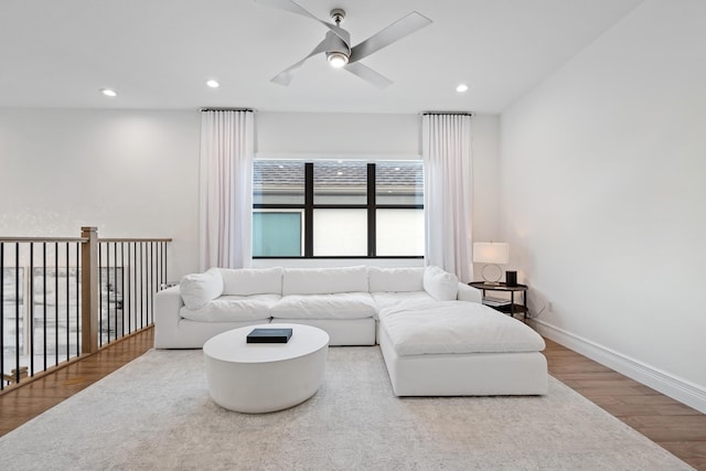 living room with wood finished floors, baseboards, a ceiling fan, and recessed lighting
