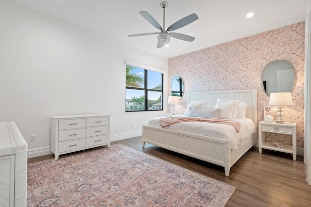 bedroom with baseboards, a ceiling fan, recessed lighting, wood finished floors, and wallpapered walls