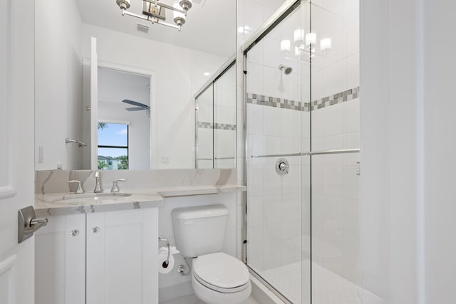 full bathroom with vanity, visible vents, a stall shower, and toilet