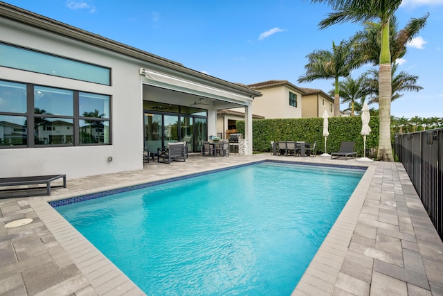 view of pool with outdoor dining area, a patio area, a fenced in pool, and fence