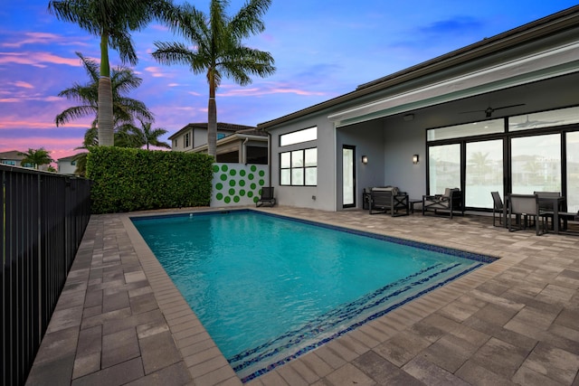 view of swimming pool featuring a fenced in pool, ceiling fan, a patio area, and a fenced backyard
