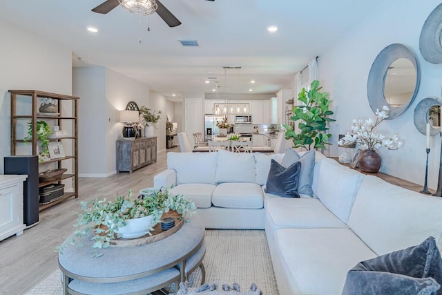 348 SE Courances Dr, Port Saint Lucie, FL 34984 - living area featuring light wood finished floors, a ceiling fan, recessed lighting, and a chandelier