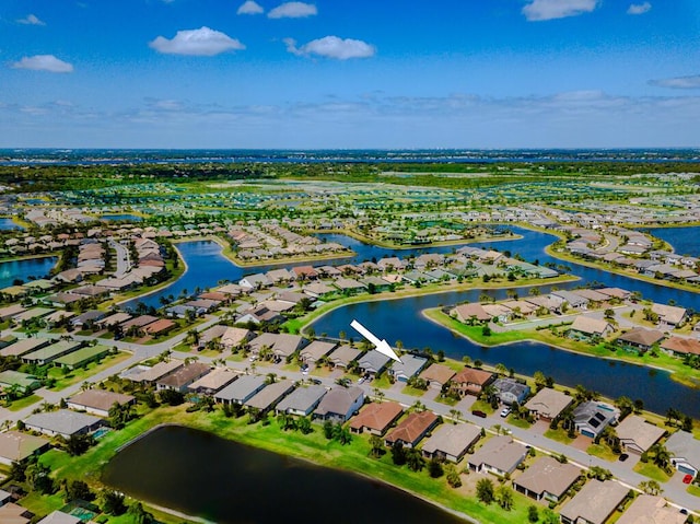 348 SE Courances Dr, Port Saint Lucie, FL 34984 - aerial view of property and surrounding area featuring nearby suburban area and a nearby body of water