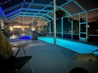 outdoor pool featuring a patio area and a lanai