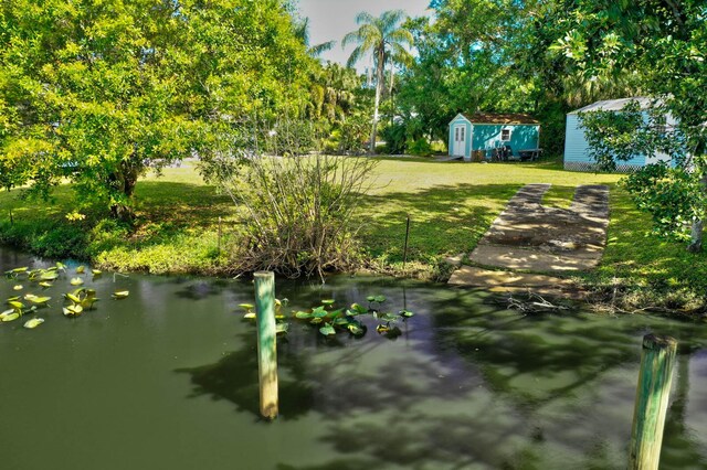 108 NE Carlisle Ln, Port Saint Lucie, FL 34952 - view of yard featuring an outbuilding and a shed