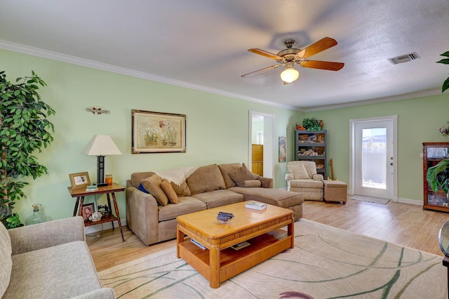 108 NE Carlisle Ln, Port Saint Lucie, FL 34952 - living area featuring light wood-style flooring, crown molding, a ceiling fan, and visible vents
