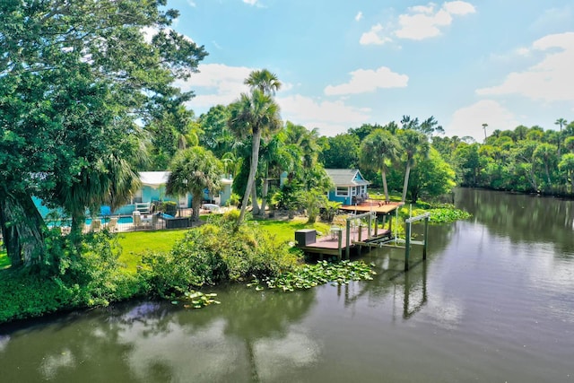 108 NE Carlisle Ln, Port Saint Lucie, FL 34952 - dock area with a yard, a fenced in pool, and a water view