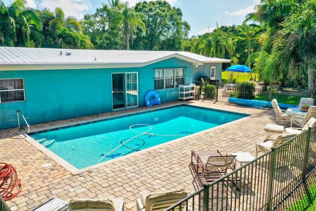 108 NE Carlisle Ln, Port Saint Lucie, FL 34952 - view of pool featuring a patio area, a fenced in pool, and fence