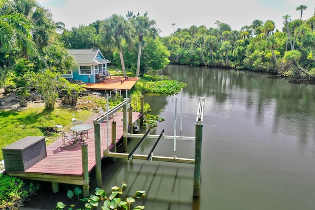 108 NE Carlisle Ln, Port Saint Lucie, FL 34952 - view of dock featuring boat lift and a water view