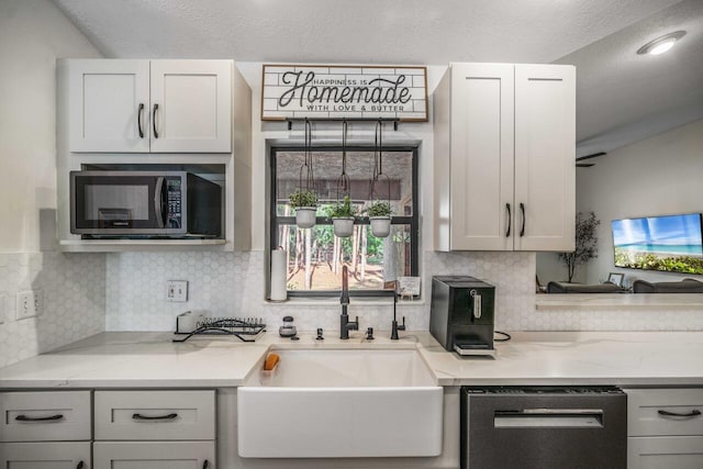 18292 126th Ter N, Jupiter, FL 33478 - kitchen with appliances with stainless steel finishes, a sink, backsplash, and light stone countertops