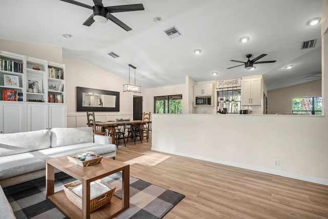 18292 126th Ter N, Jupiter, FL 33478 - living room featuring ceiling fan, lofted ceiling, plenty of natural light, light wood-style floors, and recessed lighting