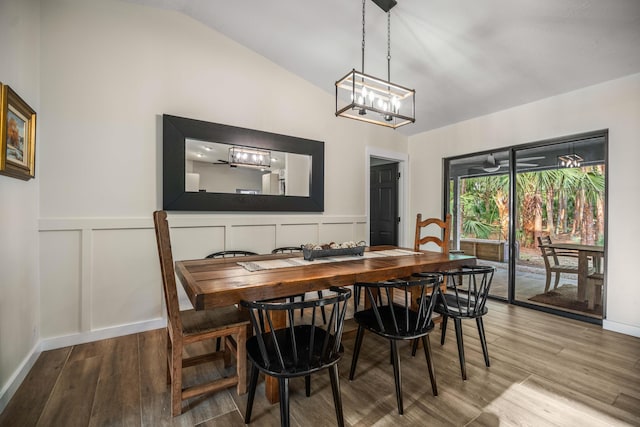18292 126th Ter N, Jupiter, FL 33478 - dining room featuring light wood finished floors, a decorative wall, a chandelier, a wainscoted wall, and vaulted ceiling